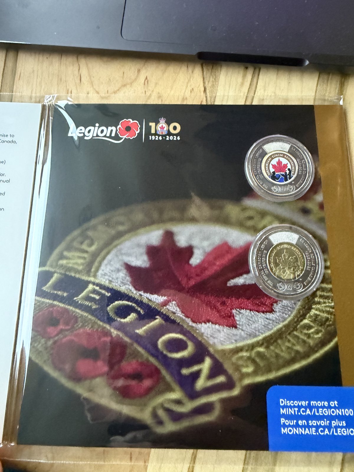 Royal Canadian Mint folder for the Legion centennial, holding two toonies, one coloured and one plain